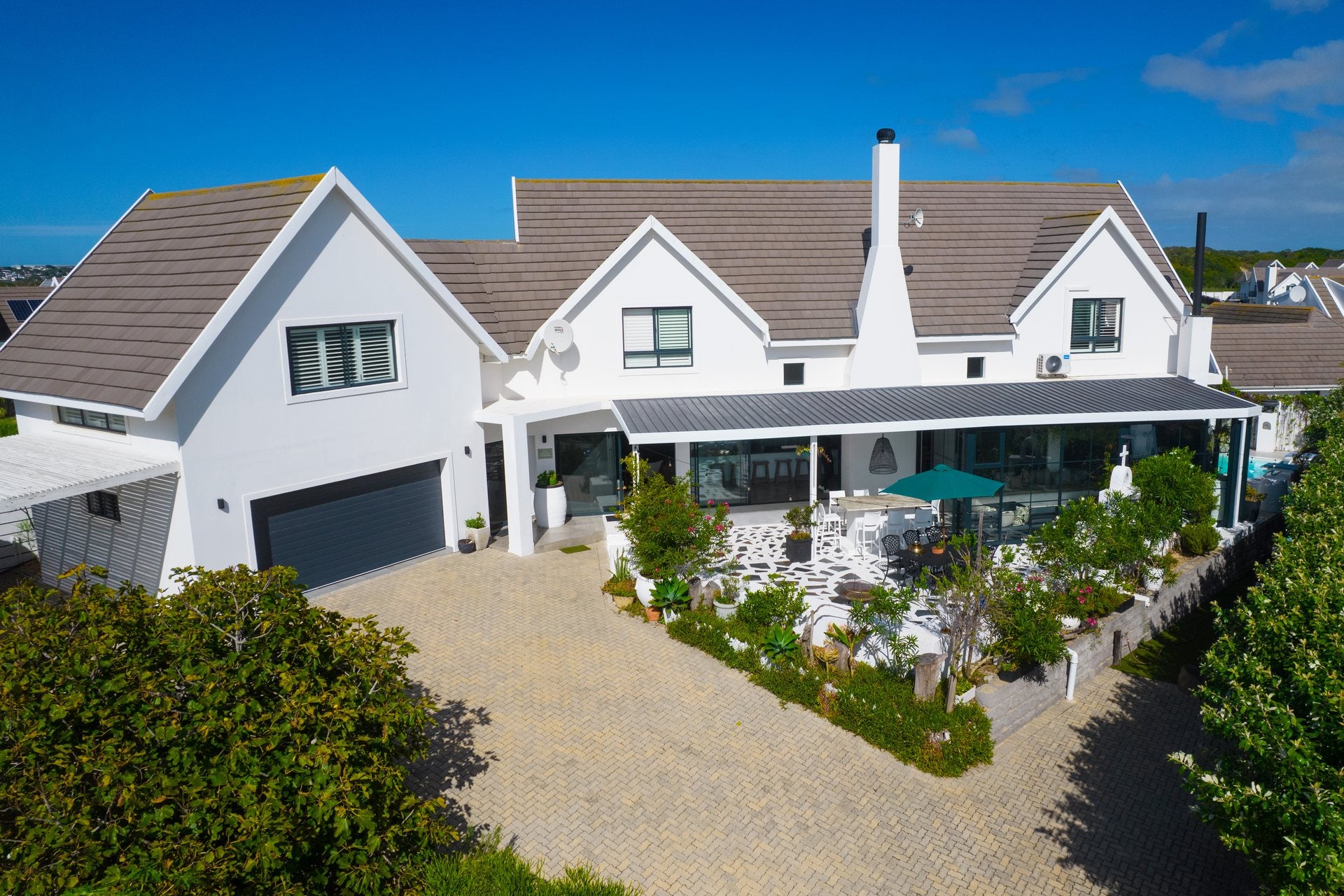 Aerial exterior photograph of a coastal home